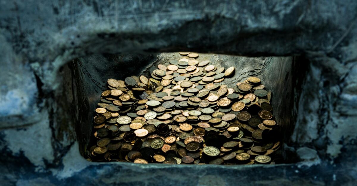 A collection of old coins nestled in a stone niche Shipka Bulgaria