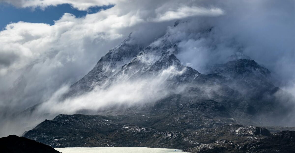 Explore the majestic misty mountains of Chile with this dramatic landscape scene