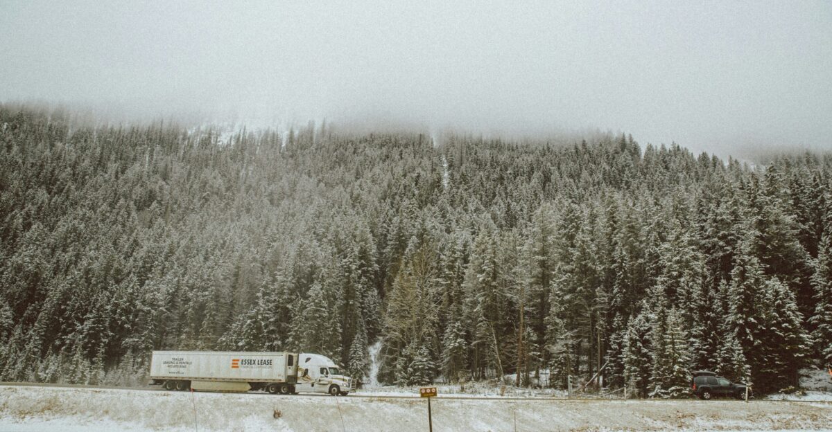 truck near trees beside mountain