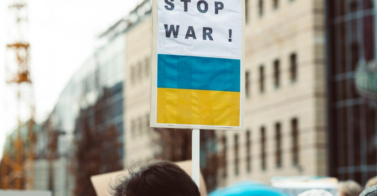 a group of people holding a sign that says stop war
