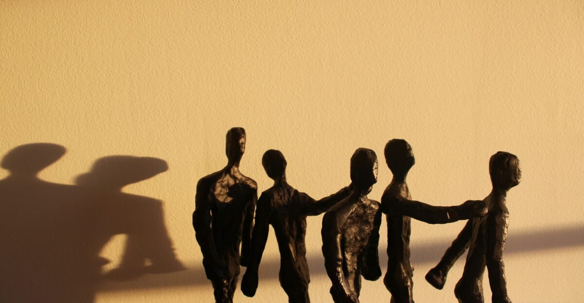 a shadow of a group of people holding hands