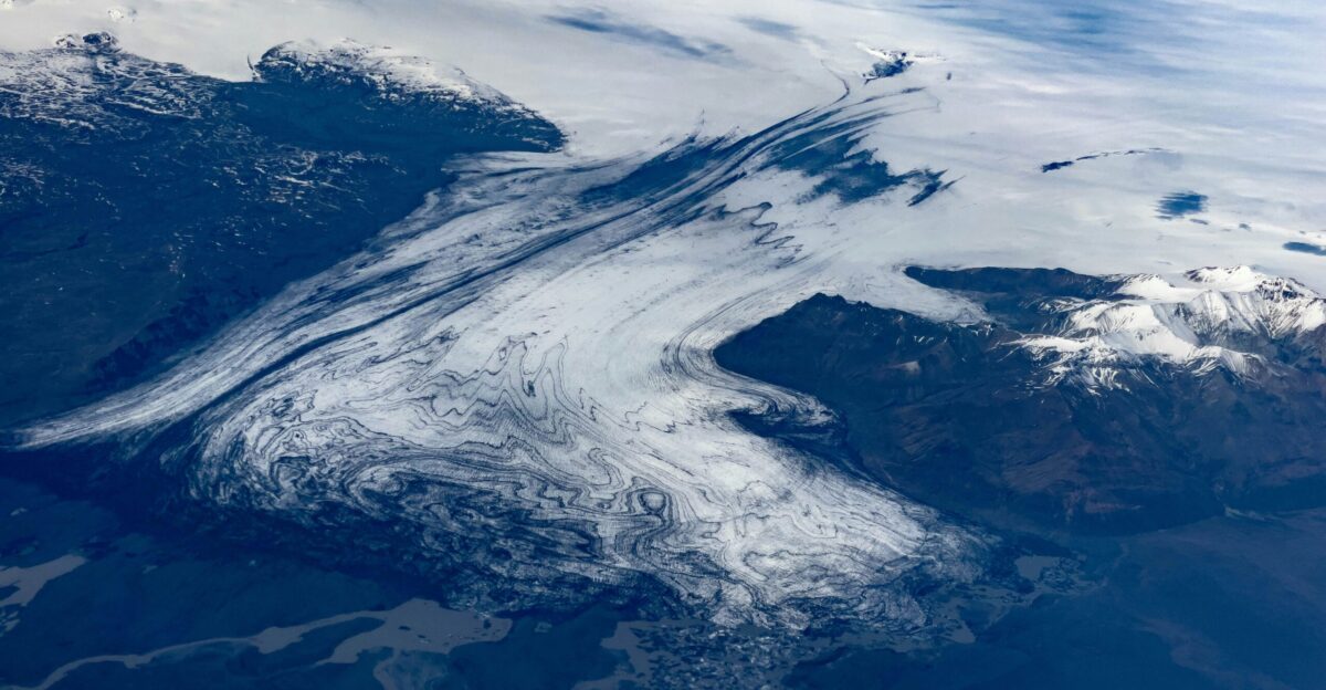 an aerial view of a snow covered mountain range