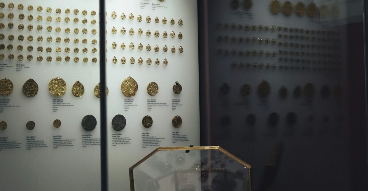 a display case with a variety of gold coins