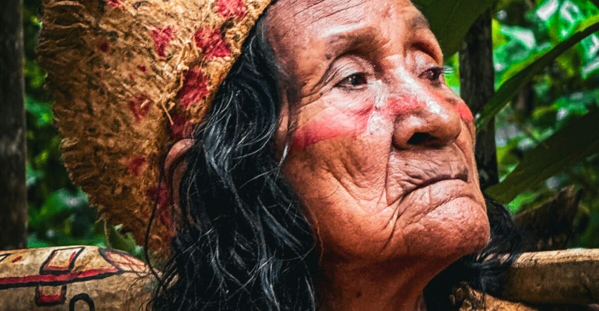 An old woman with a drum in her hand