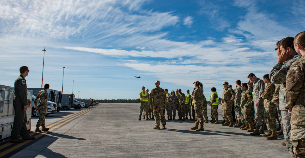 th Expeditionary Air Mobility Unit personnel watch an F-22 Raptor take off from the Royal Australian Air Force Base Amberley flightline July 13 The United States and Australian forces combine biannually for Exercise Talisman Saber 19 a month-long multi-domain battle that strengthens allied and partner capabilities to make both forces interoperable in operational environments U S Air Force photo by Staff Sgt Kyle Johnson
