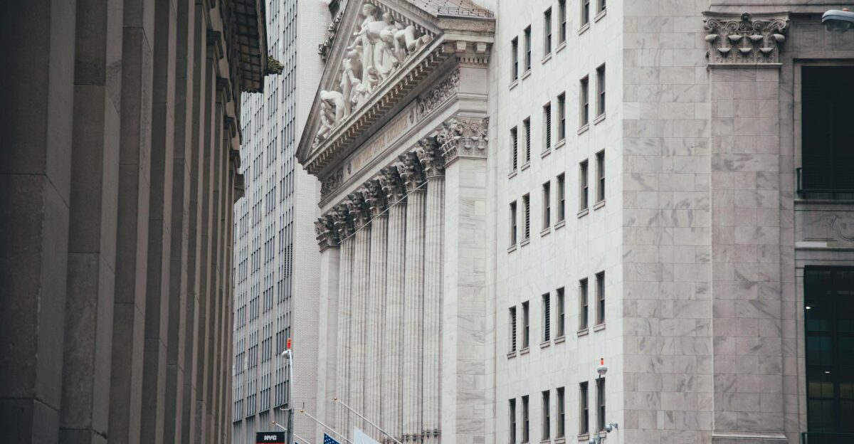 Historic architecture of Wall Street with American flags in New York City USA