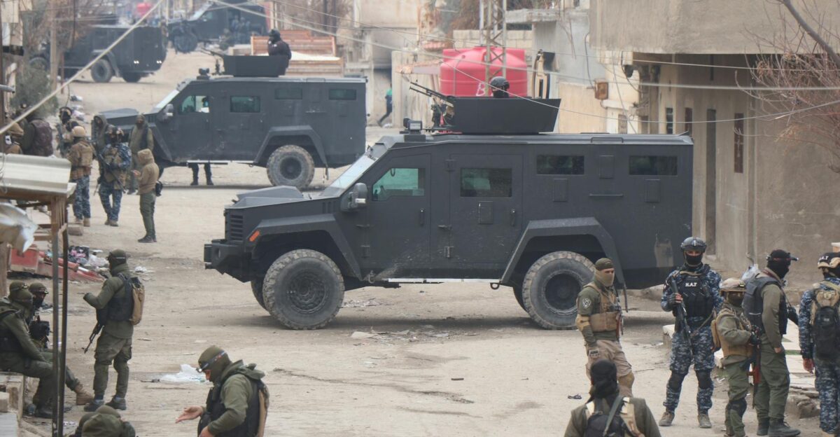 Armed forces in armored vehicles on the streets of Al Hasakah during a military operation
