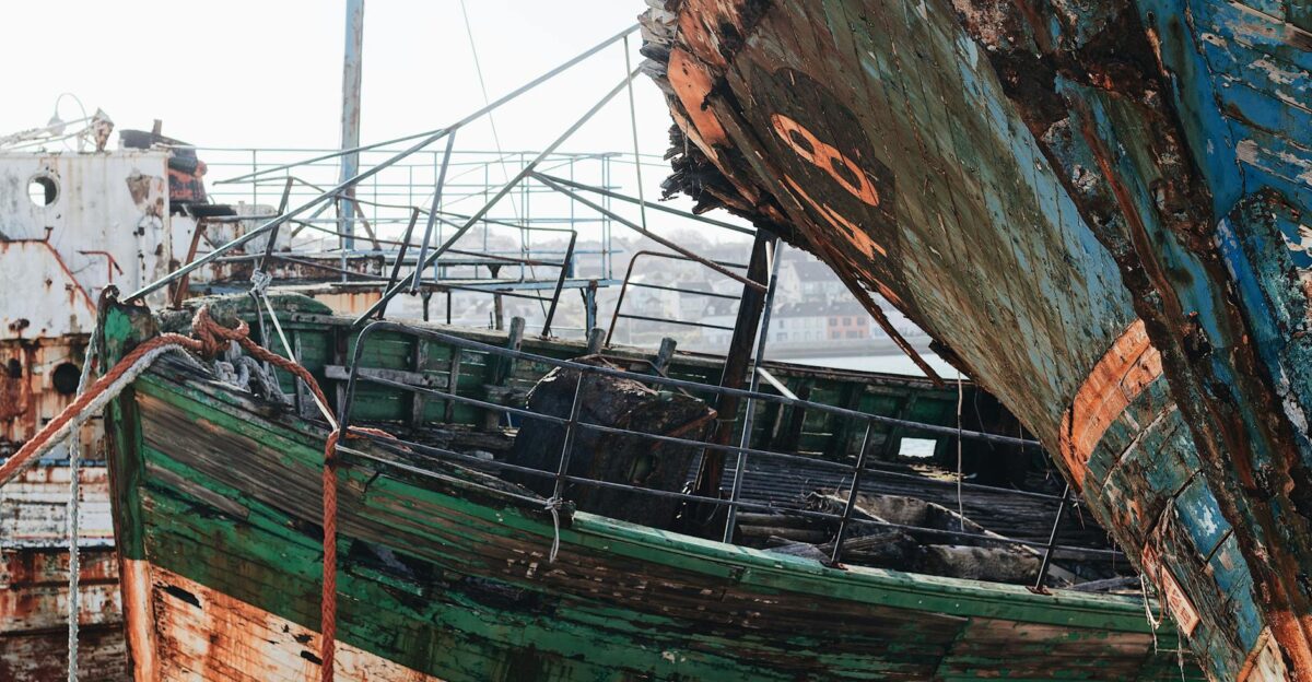 A detailed close-up of a decaying shipwreck with rust and peeling paint evoking a sense of history and abandonment