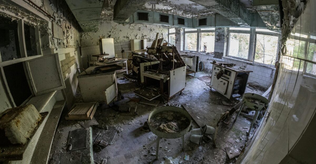 An eerie interior of an abandoned laboratory showing decaying equipment and desolate atmosphere