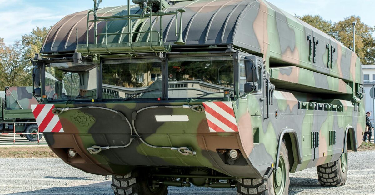 Front view of a camouflage military vehicle displayed outdoors in Hamburg Germany