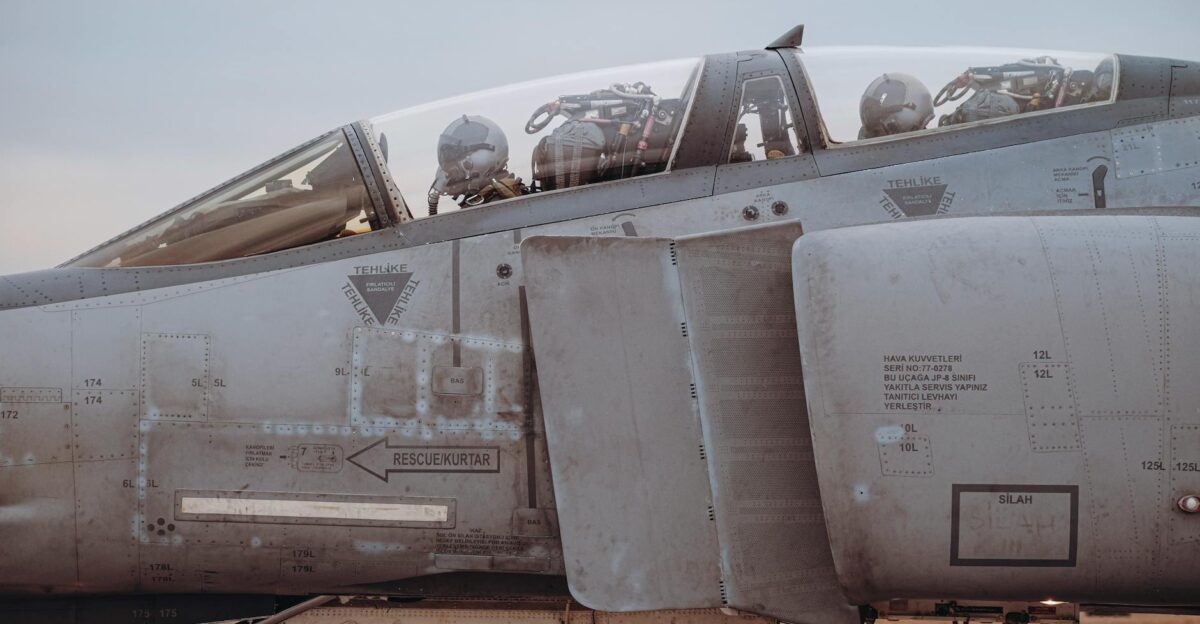 Detailed view of a military jet fighter cockpit with pilots under preparation showcasing aviation precision in T rkiye