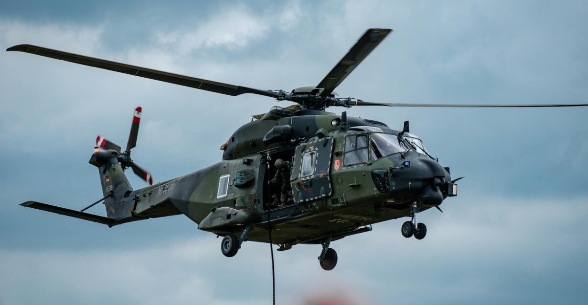 Military helicopter flying through cloudy skies during a training exercise