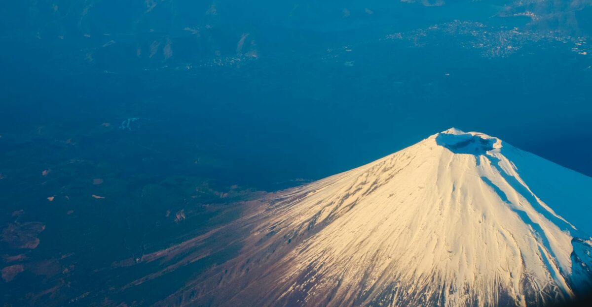 Stunning aerial view of Mount Fuji s snow-capped peak during winter capturing its majestic beauty