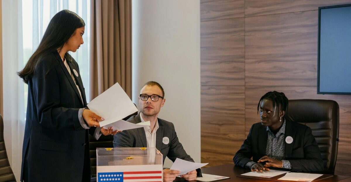 A diverse group of professionals deliberating in a conference room about election plans