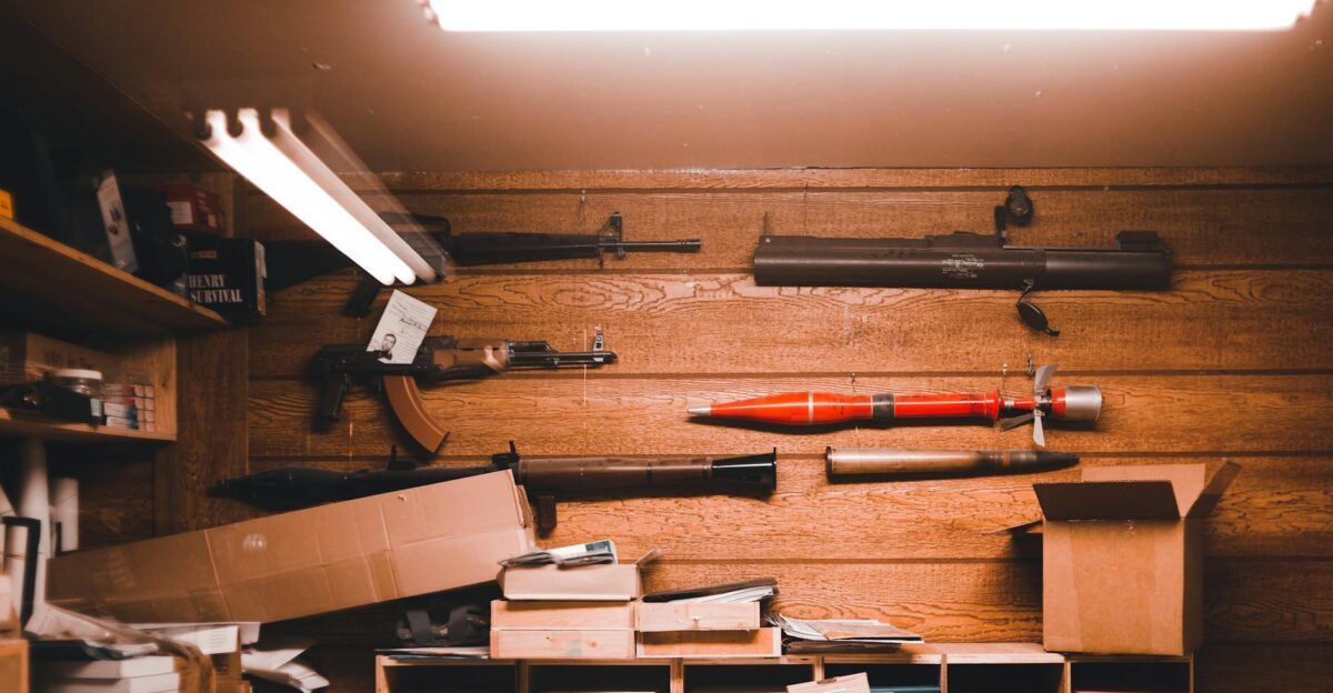 Interior of an armory with wooden walls weapons and equipment stored in boxes