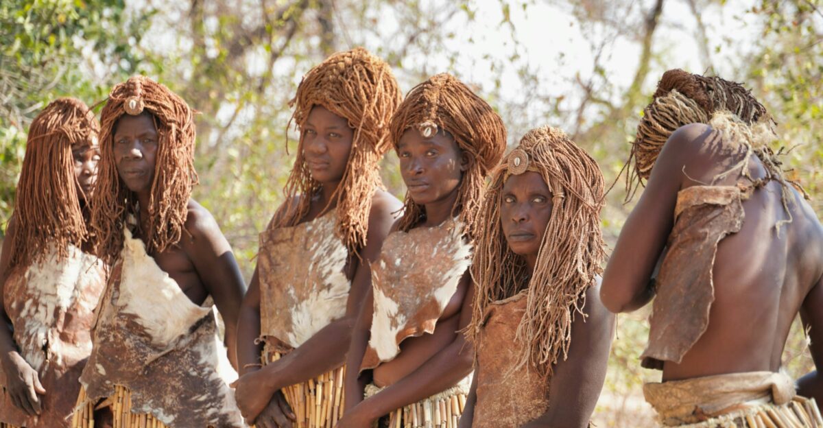 women in white dress standing on brown soil during daytime