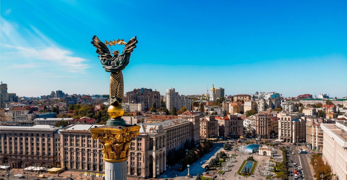 a view of a city with a statue in the middle
