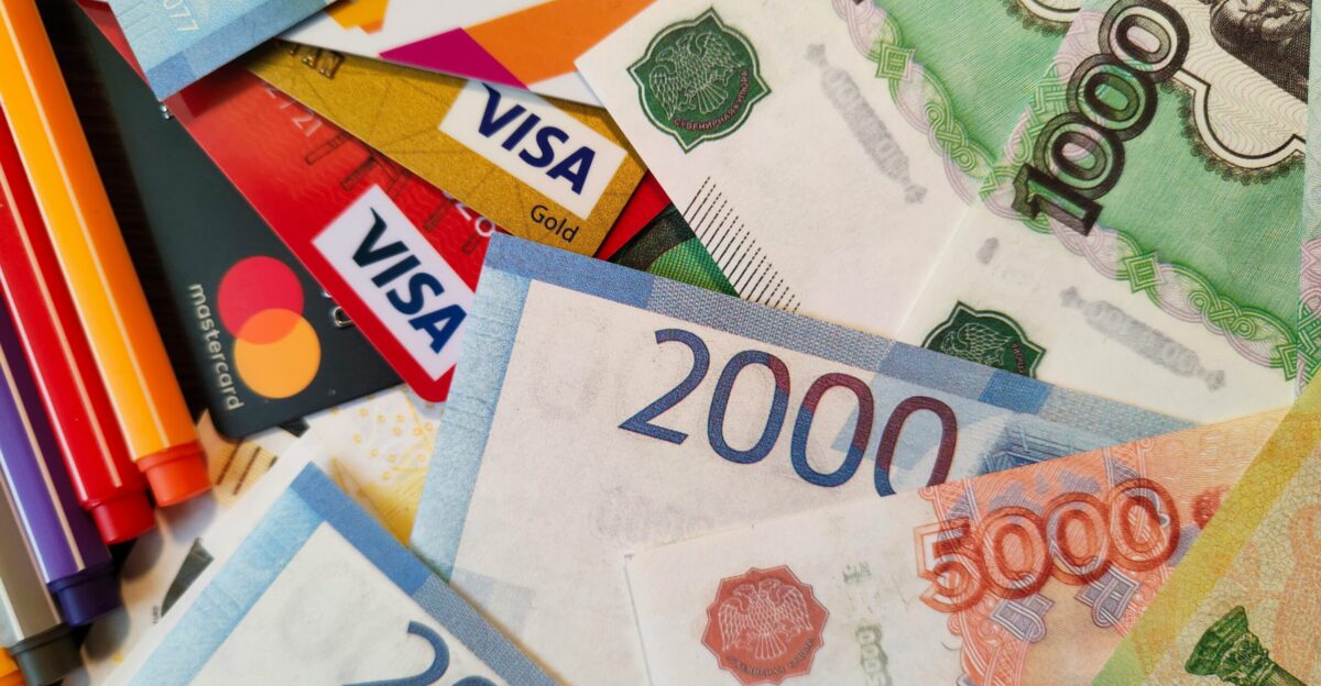 a pile of different currency sitting on top of each other