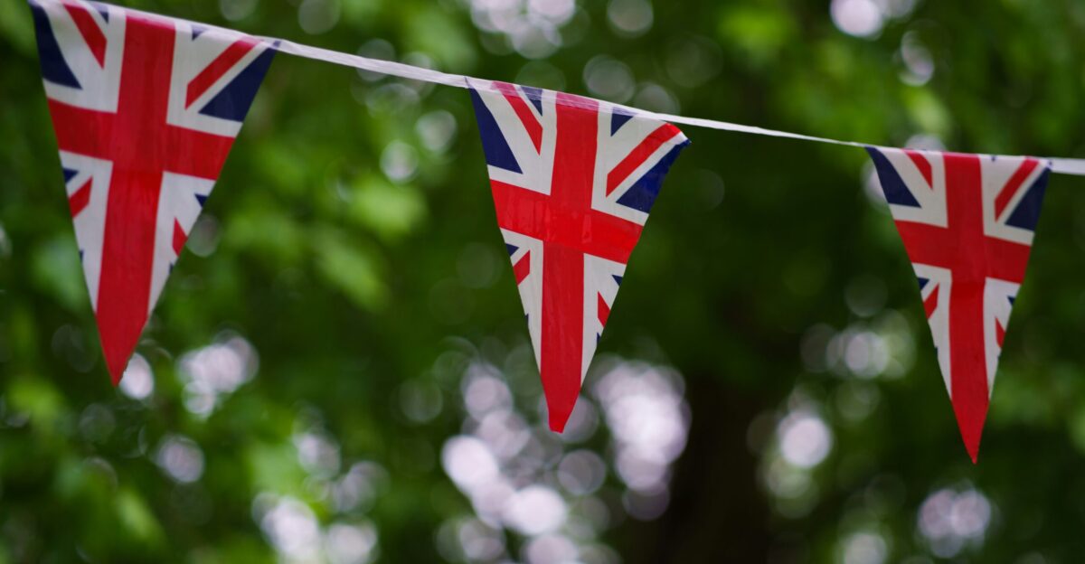 a british flag bunting on a tree line