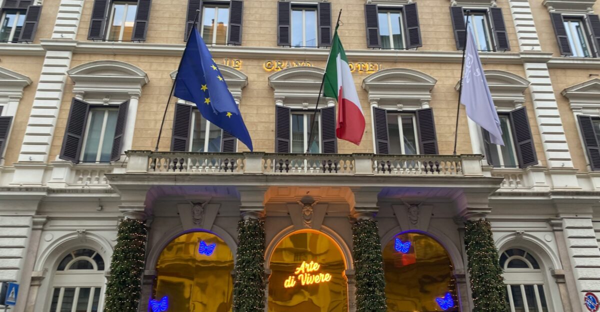 a large building with a bunch of flags in front of it