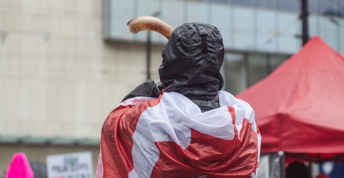 a statue of a man with a canadian flag draped around his shoulders