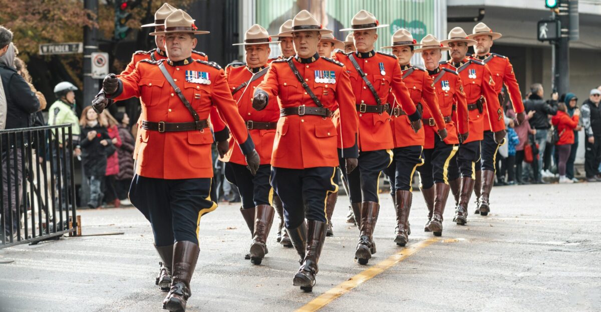 a group of men in red uniforms marching down a street