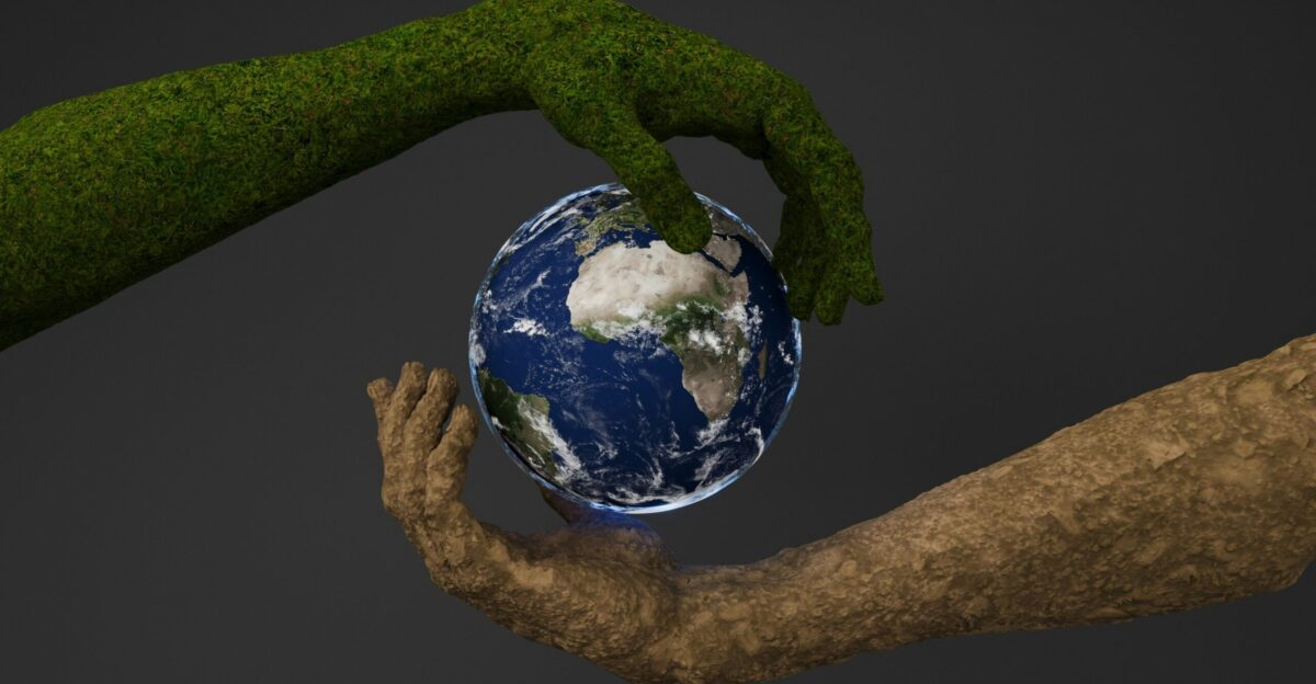 Two hands are holding a small earth globe