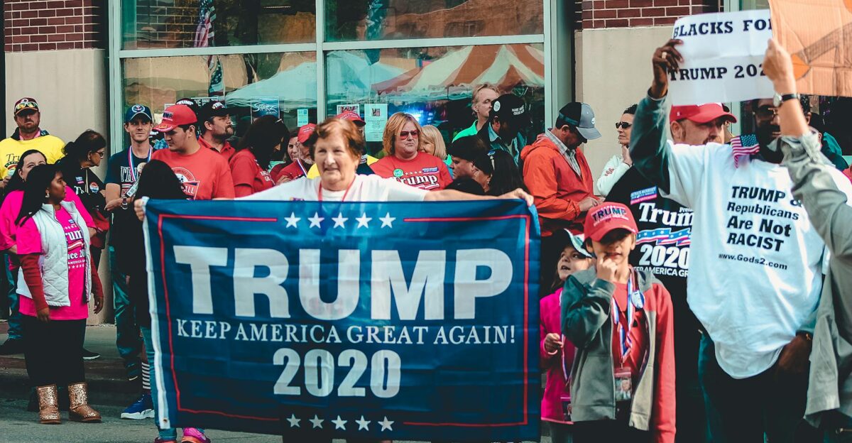 A crowded political rally in Wheeling showcasing Trump supporters with banners and signs