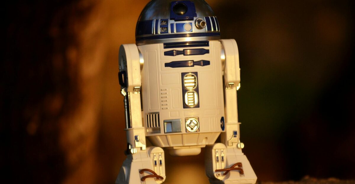 Close-up of a futuristic robot toy outdoors showcasing its metallic and plastic components