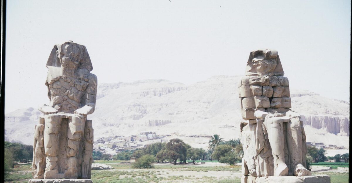View of the Colossi of Memnon statues in Luxor Egypt highlighting ancient Egyptian architecture