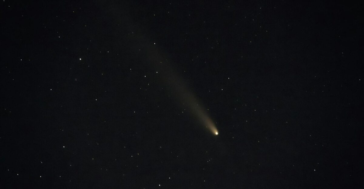 A mesmerizing view of a comet streaking across a star-filled night sky in H llhorst Germany