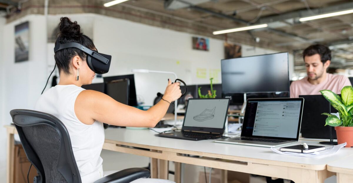 Woman using virtual reality headset in a modern office for design and innovation