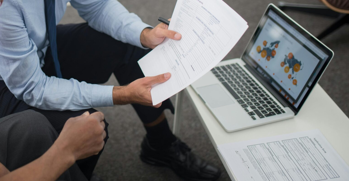 Financial advisor discussing documents with senior clients in an office setting, showcasing a collaborative consulting session.