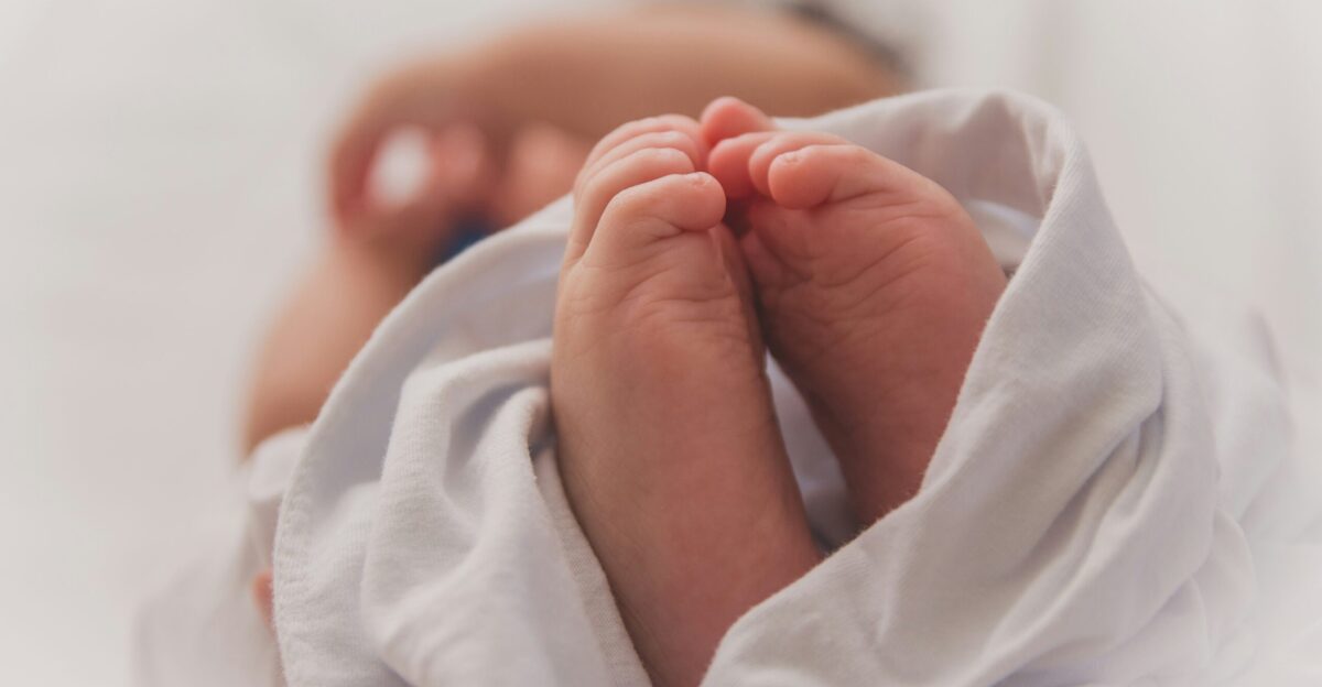 baby covered with white blanket