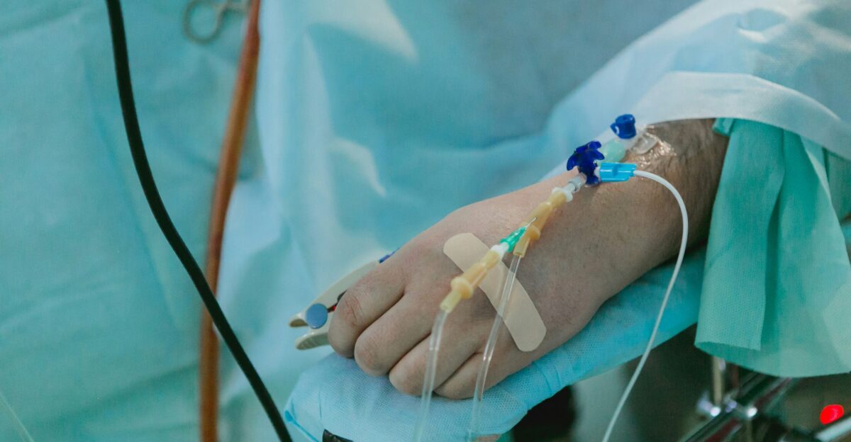 a person in a hospital bed with an iv