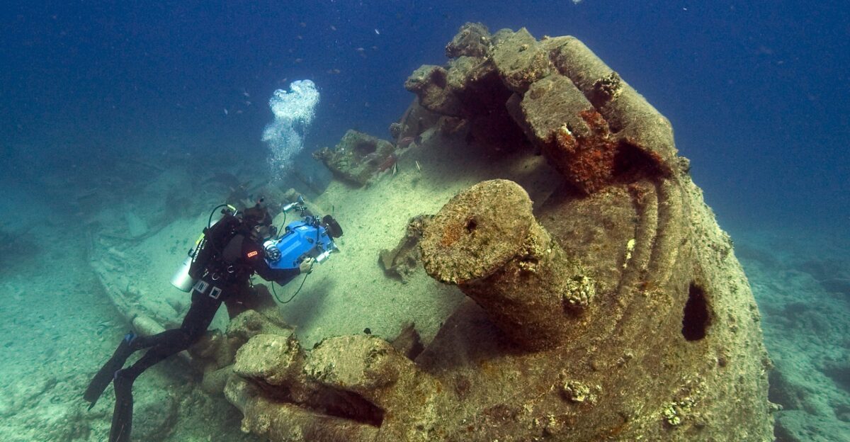 person scuba driving underwater