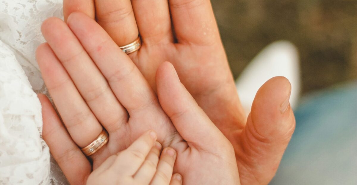 person wearing gold wedding band