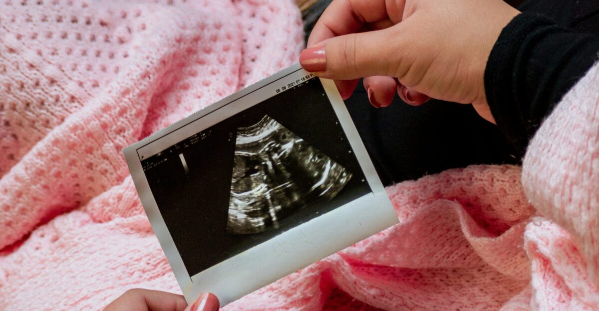 a person is holding a picture of a baby