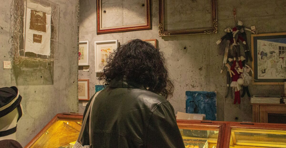 a woman looking at a display case in a museum