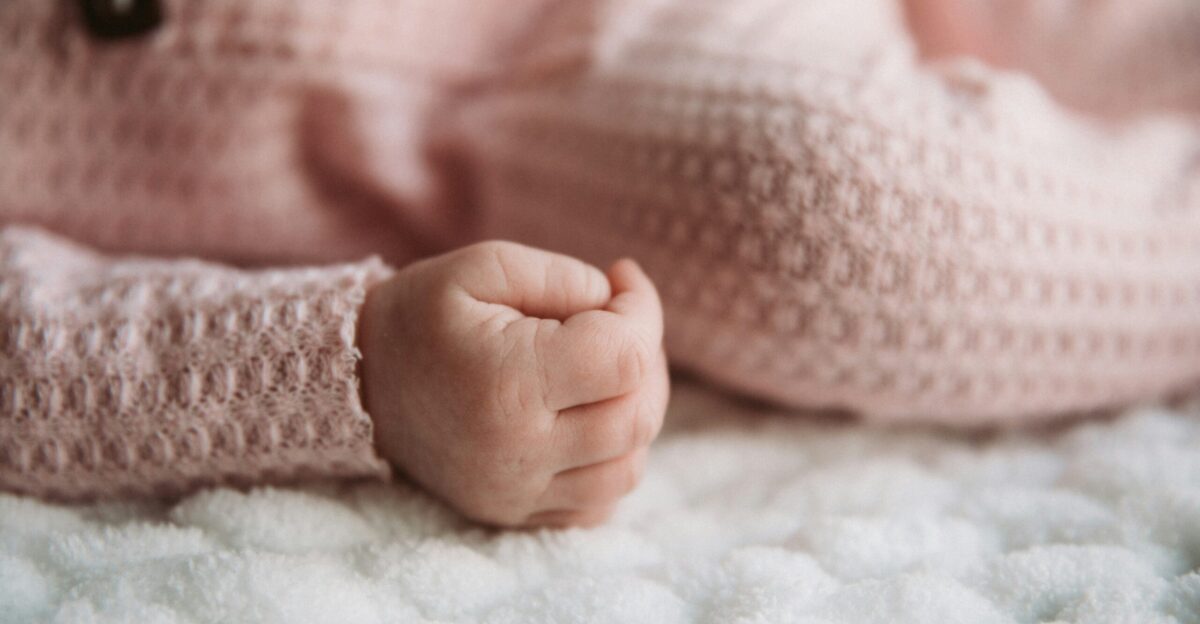a close up of a baby laying on a blanket